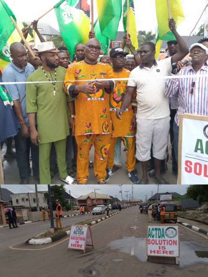 Awka Ward 8 Chairman, Mr Nathan Obikwelu (3rd left) performs a symbolic tape cutting ceremony amid party faithful and commercial tricyclists and motorcyclists in the area, recently